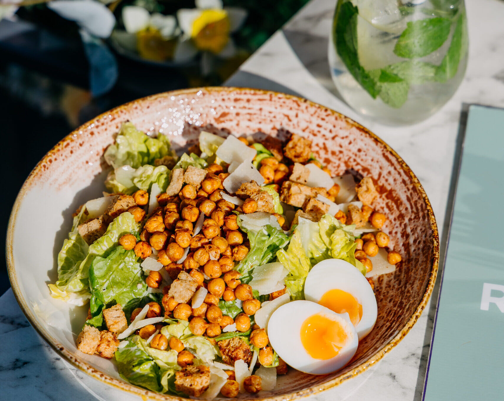 vegetatian bowl including chickpeas, eggs, salad