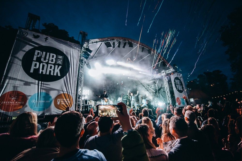 Pub in Park Brighton. The stage is lit in the background, thousands of people are in front of the stage.