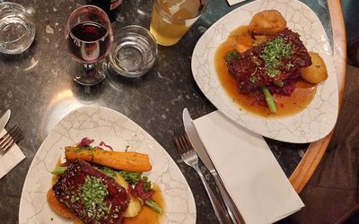two vegan nut roasts with veg, wine and cider