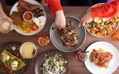 over head shot of table with brunch served at Baked in Hove. Listed in our places to eat in Brighton