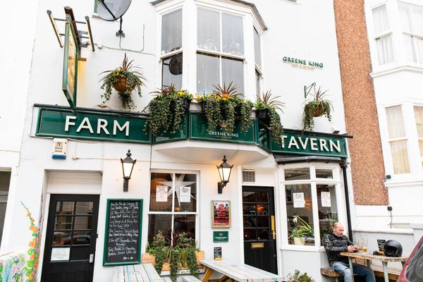 exterior shot of the white building of The Farm Tavern pub in Hove