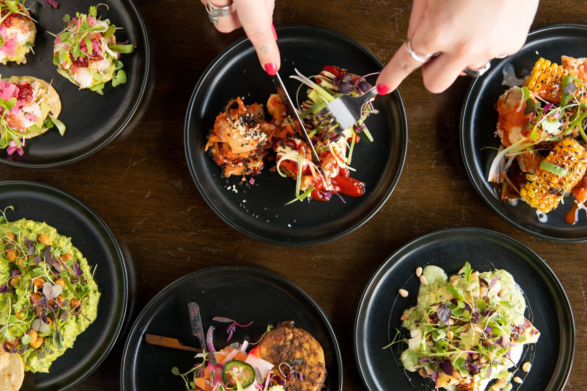 six different small plates with food