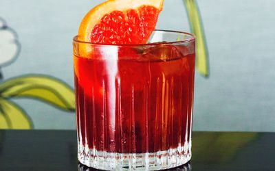 red cocktail in small glass, piece of orange attached. A brighton seafront bar, located a stone throw back from the coast road in Kemptown