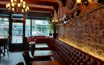 Furnished with wooden tables, luxurious leather chairs and banquette seating at the paris wine bar in hove