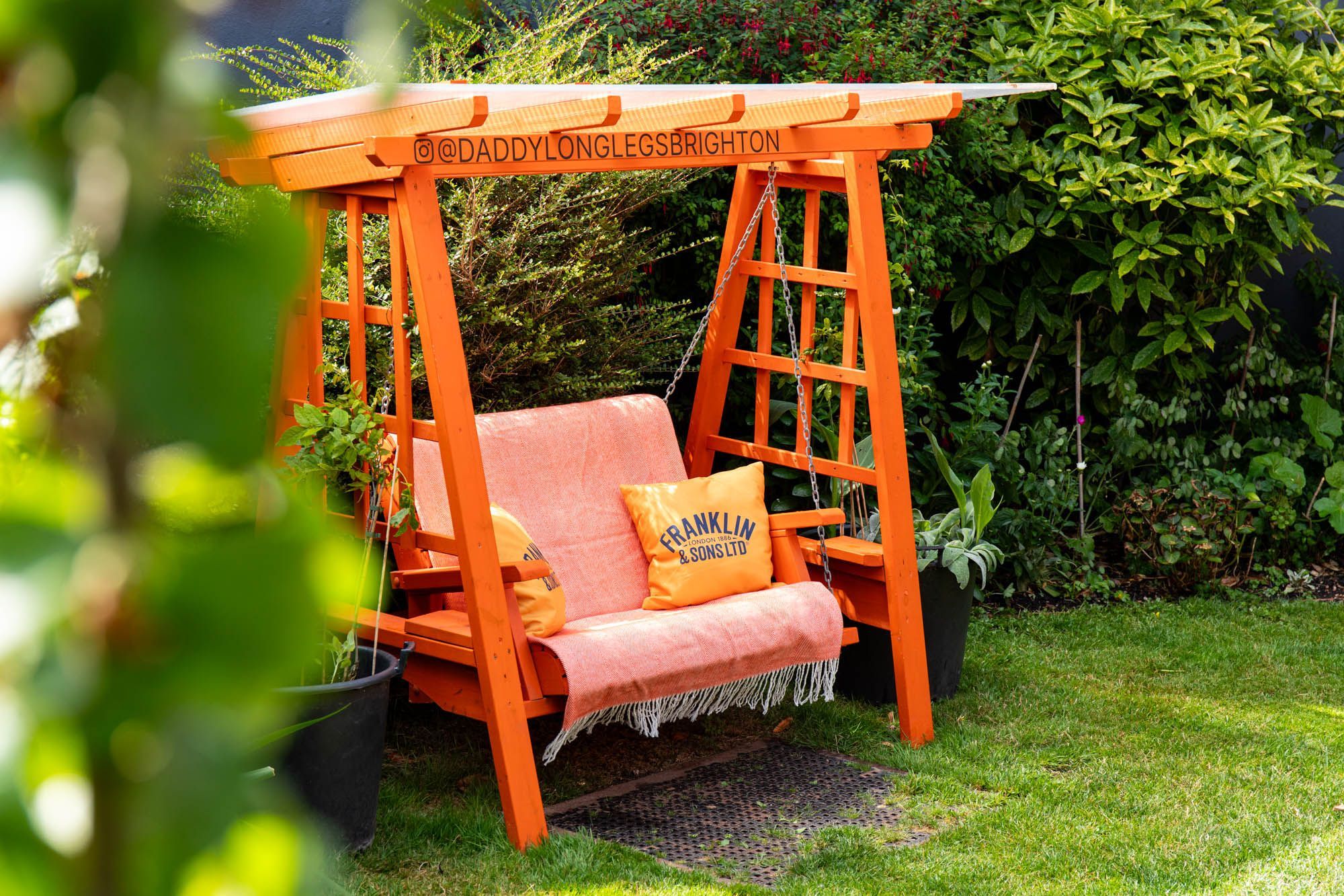 comfy orange coloured garden swing at DaddyLonglegs