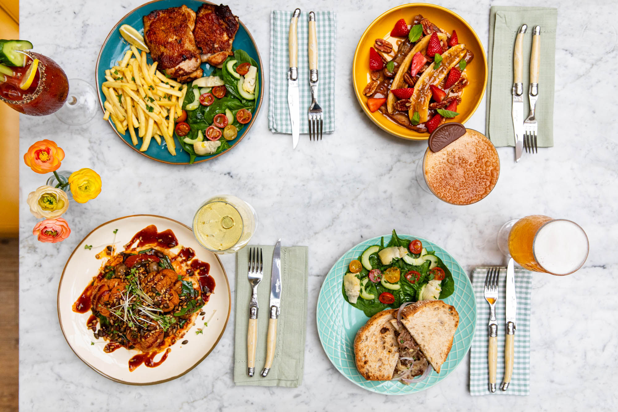 Plates of food photographed from above on a marble table. This is lunch at Jo and Co