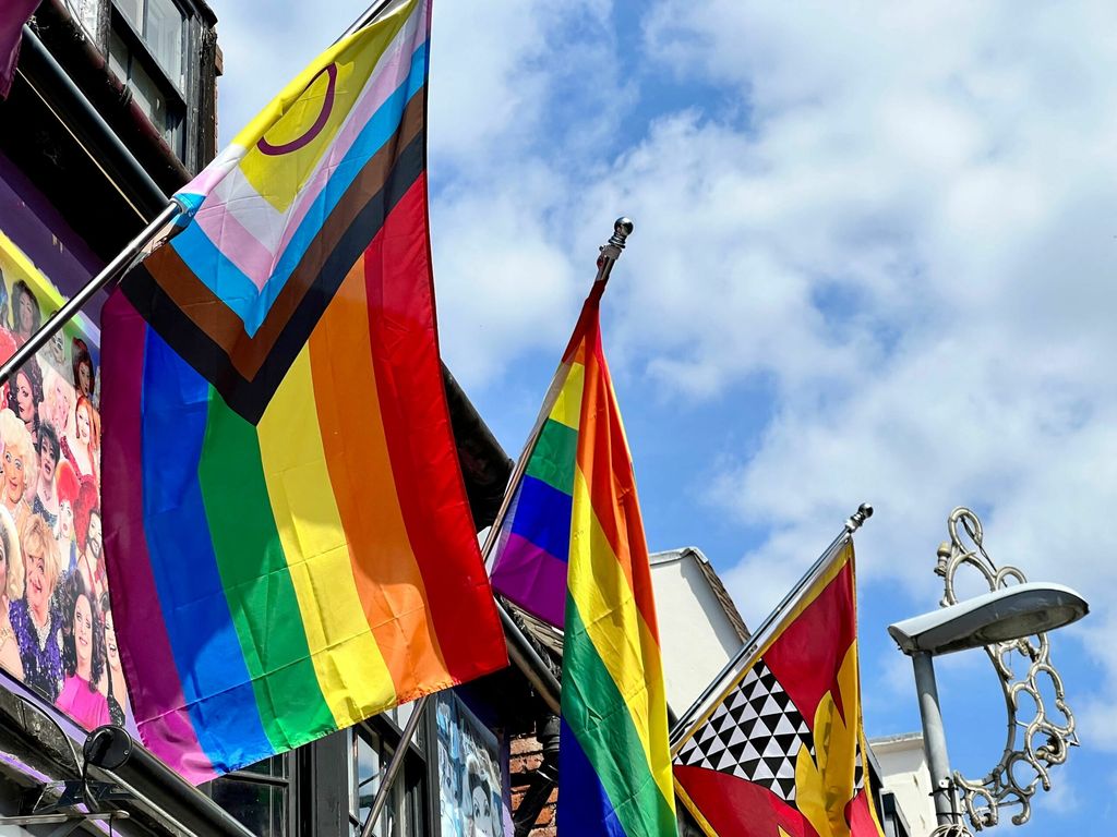 Gay Bars Brighton round up. The Pride flag or rainbow flag on the side of a building in Kemptown.