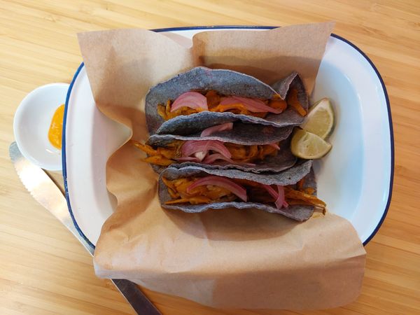 blue corn tacos with an oyster mushroom and picked red onion filling