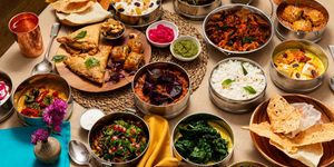 close up side shot of the Majahma tiffins and the rest of the dishes served on board, couple of glasses of water included