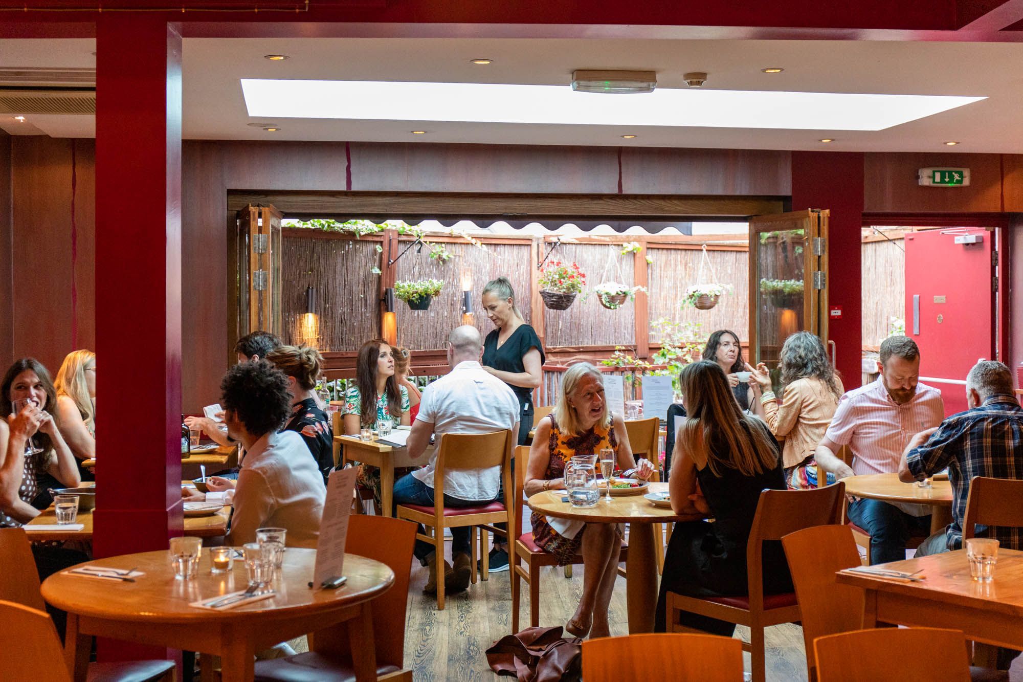 interior of Terre a Terre restaurant, people dining by the tables