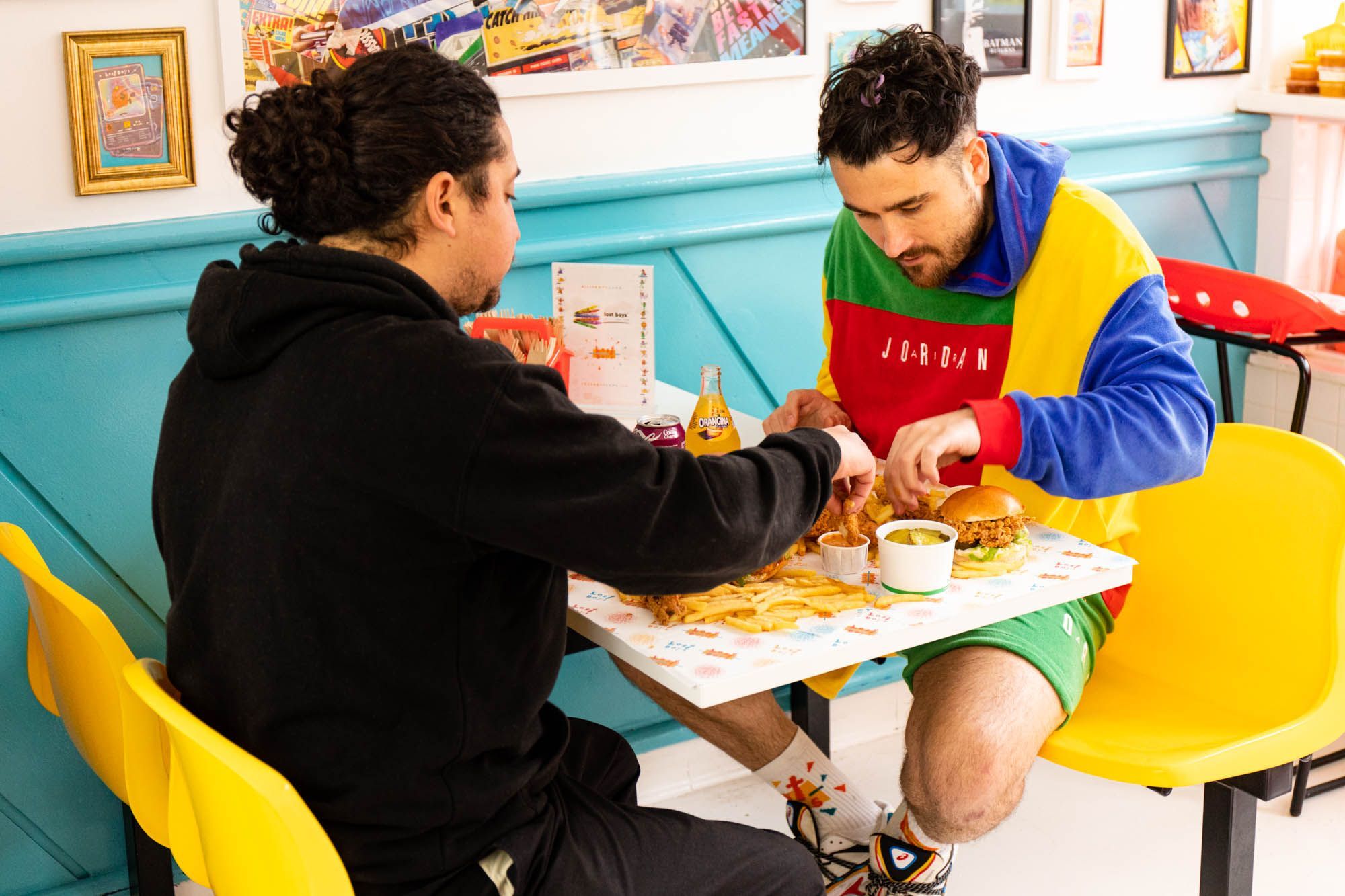 Tom and his friend enjoying chicken and burgers at the Lost Boys Land