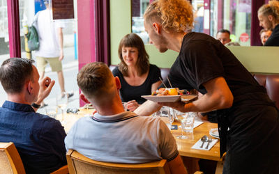 waiter serving food to the customers