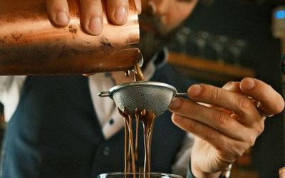 bartender making cocktails. A copper cocktail shaker. Making an espresso martini. Bars in brighton guide