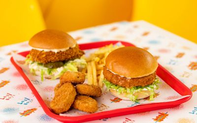 two chicken burgers and chicken nuggets on the tray at Lost Boys Land