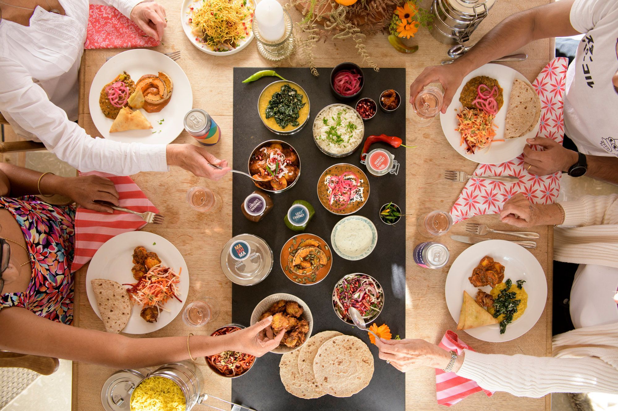 over head shot of four people having a feast by the table