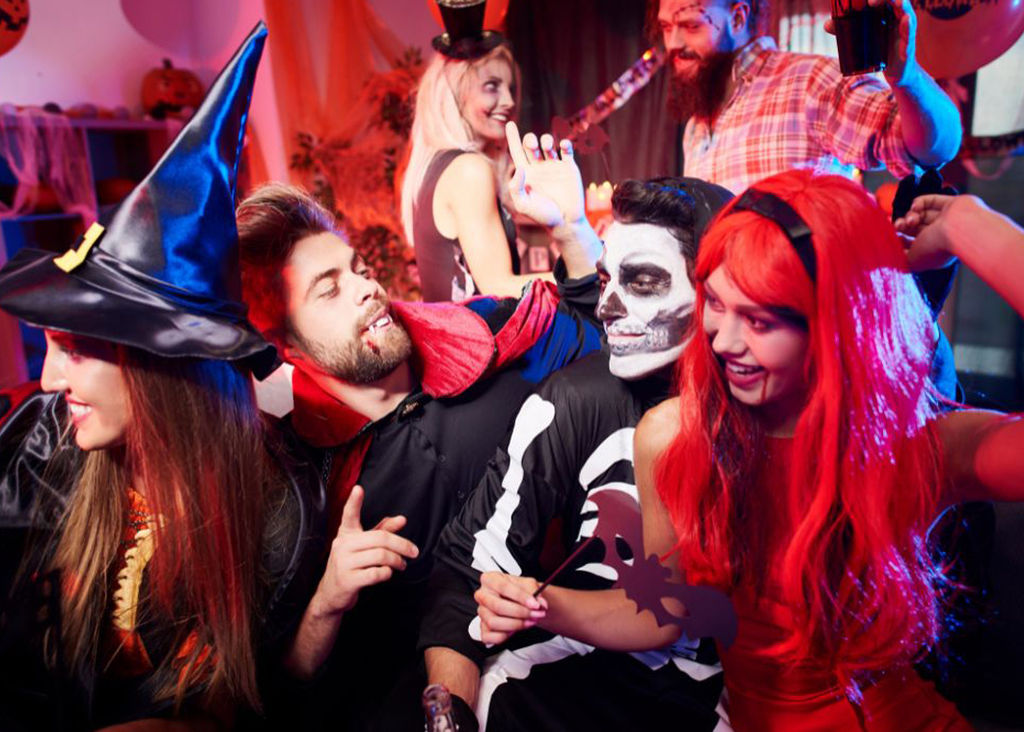 People in fancy dress at a Halloween party.