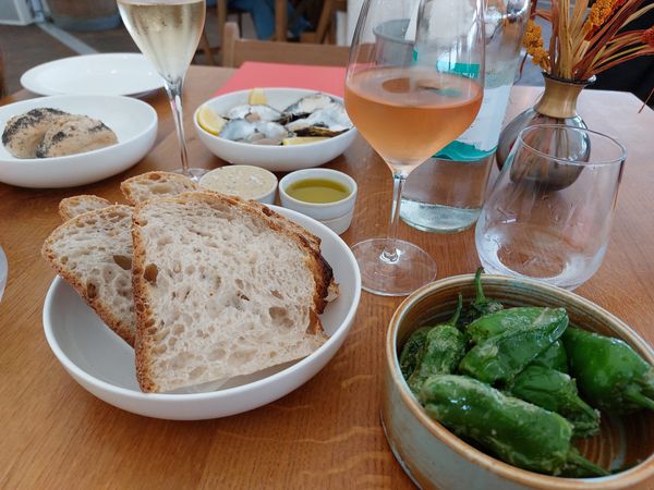 low table shot, padron peppers, sourdough, oysters and glasses of wine