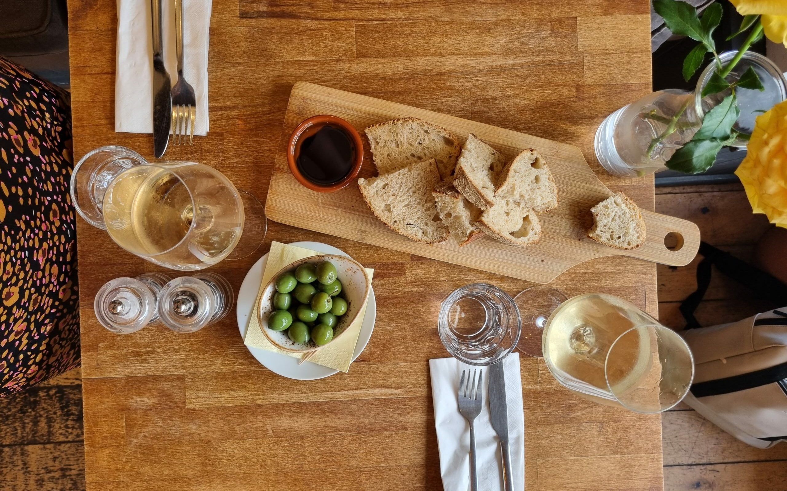 over head shot of the table laid out with board with fresh bread and olive