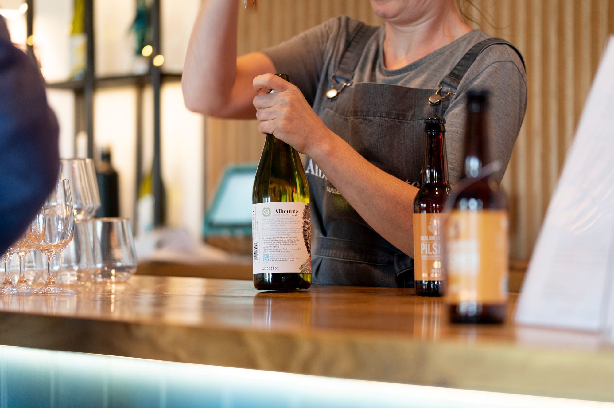 bartender opening bottles of wine 