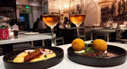 two small plates served with two glasses of wine