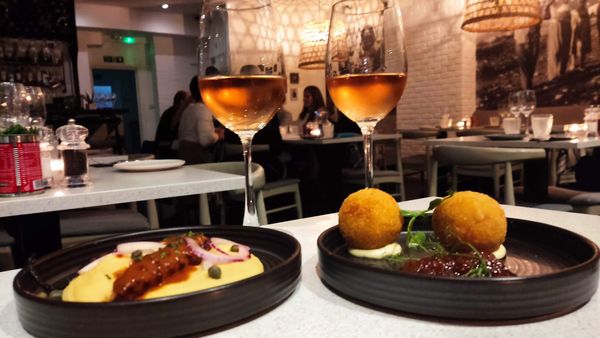 two small plates served with two glasses of wine