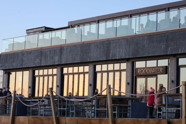 Image of a modern building with sun shining on the windows.