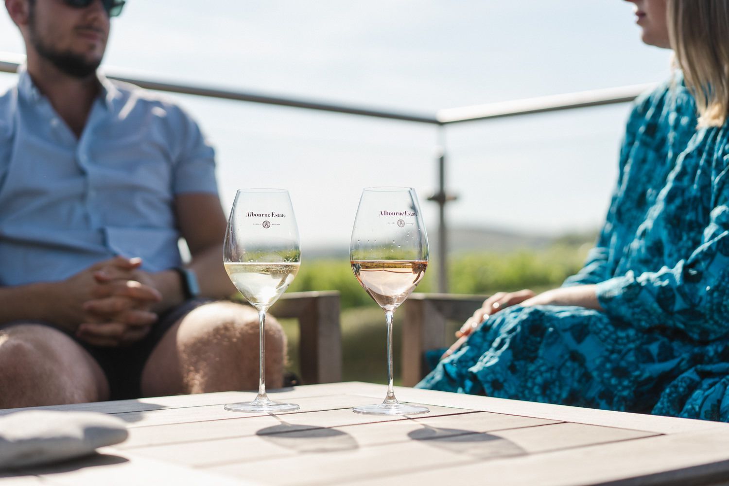 man and woman enjoying their wine on the terrace