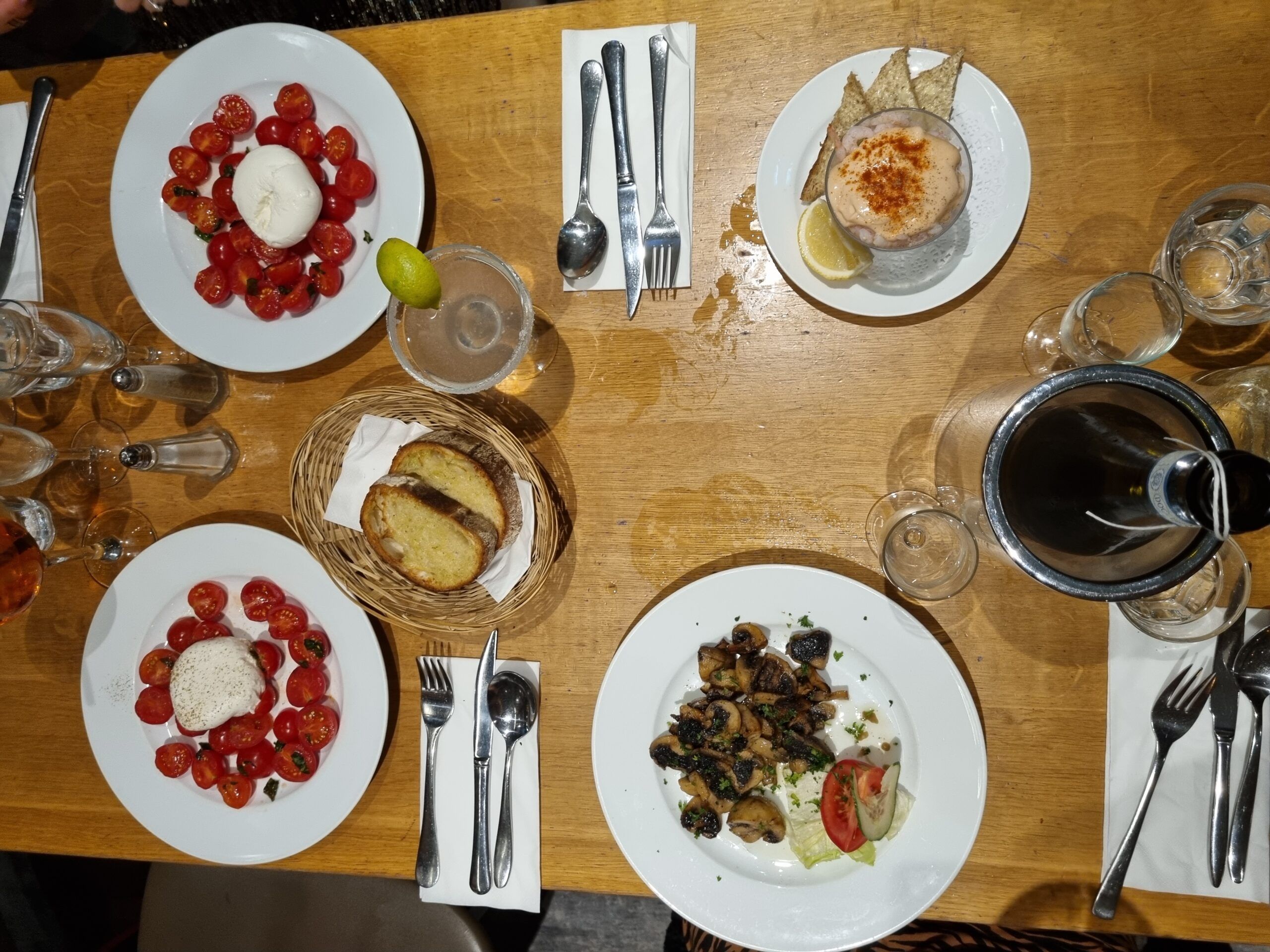 two orders of beautiful burrata with fresh cherry tomatoes and basil, a generous portion of classic prawn cocktail, and our veggie had the sauteed mushrooms with crunchy garlic bread. Ladies night at Donatello Restaurant