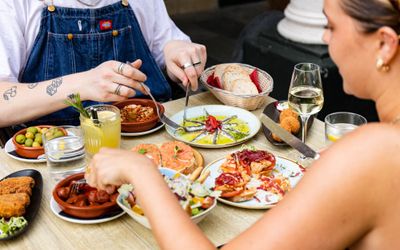 two women sharing 9 different small plates at Spanish restaurant Tinto Taperia. Small Plates Brighton round-up