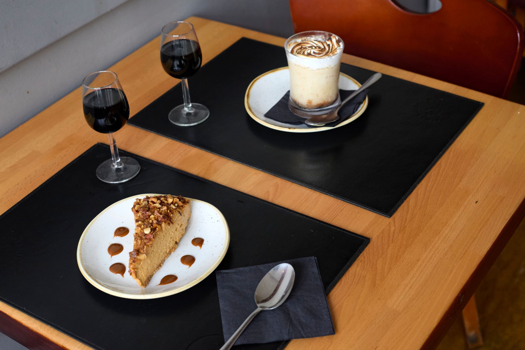 two delicious desserts served with glass of red wine - Latinoamérica Hove