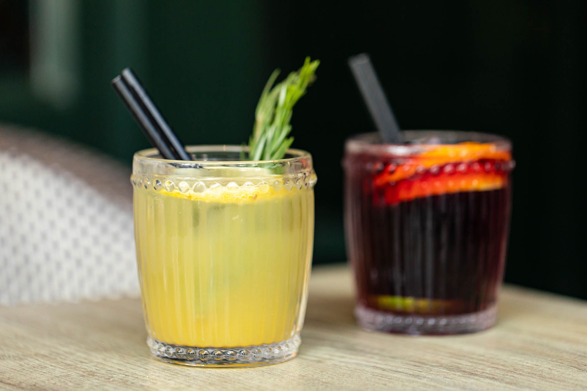 yellow and black cocktails in the small glasses at Tinto Taperia table