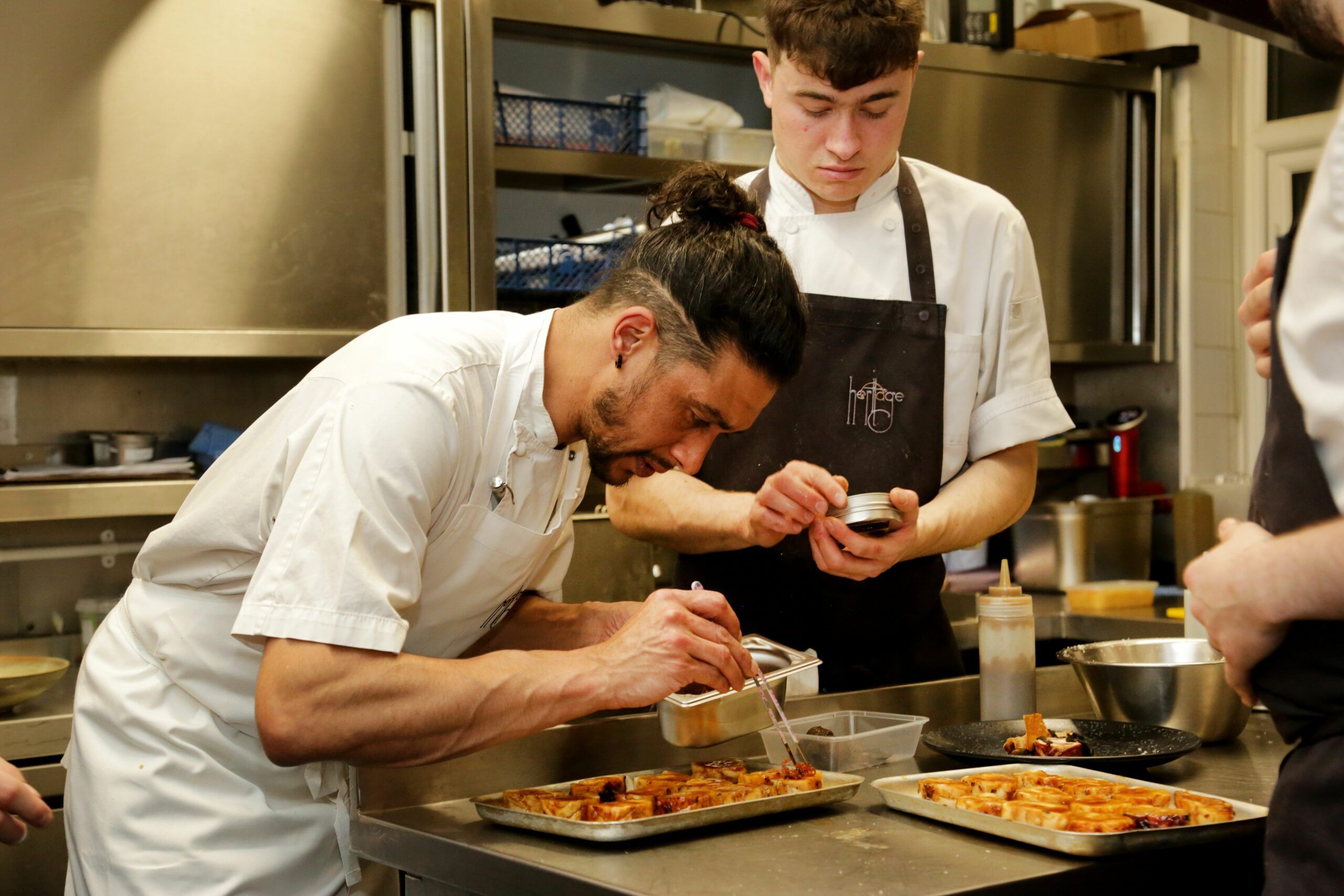 two chefs preparing dishes