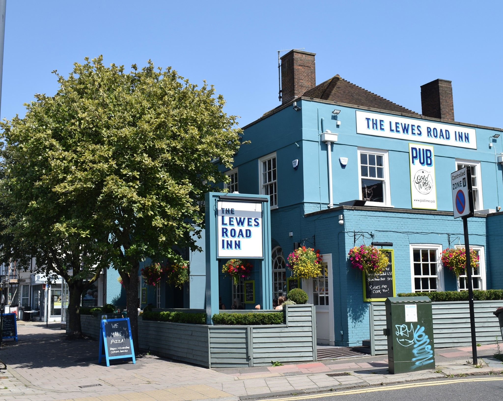 striking all blue exterior of the Lewes Road Inn Brighton showing bold black and white signage