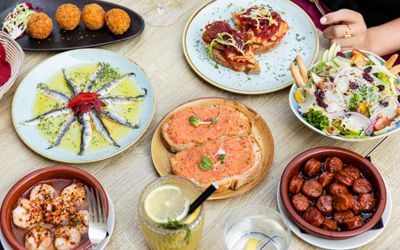 over head shot of the seven different small plate at the Spanish restaurant Tinto Taperia