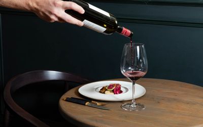 waiter sipping red wine into wine glass at the Furna Brighton