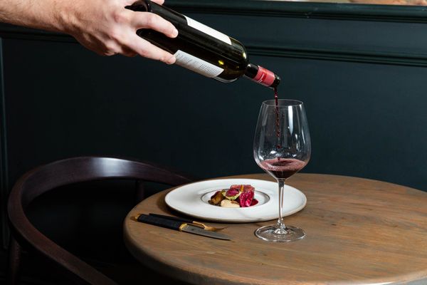 waiter sipping red wine into wine glass at the Furna Brighton