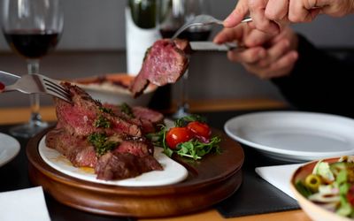 person taking one piece of steak at Hove restaurant