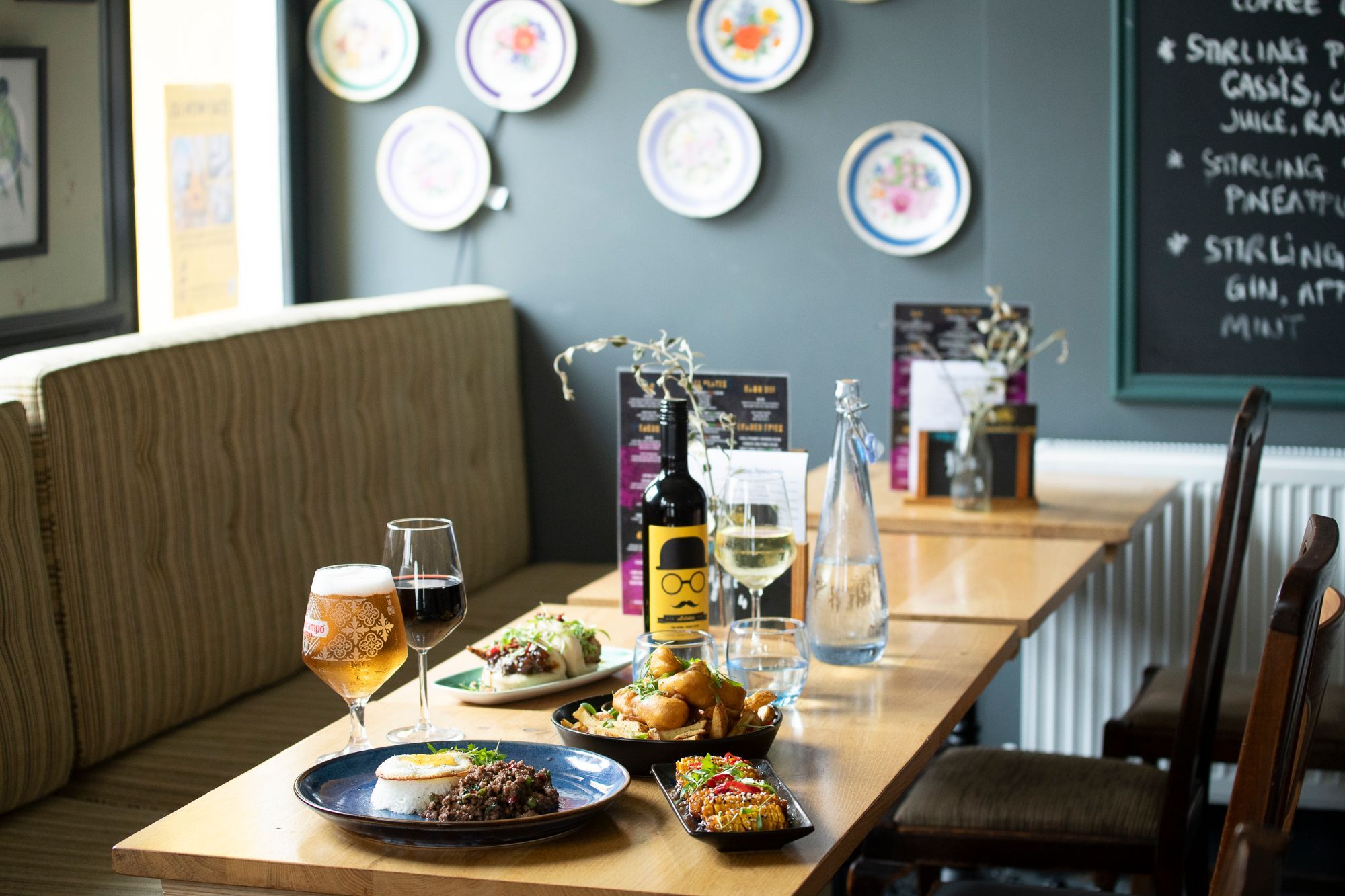 side shot of the brown wooden table laid out with lunch and drinks at the Stirling Arms