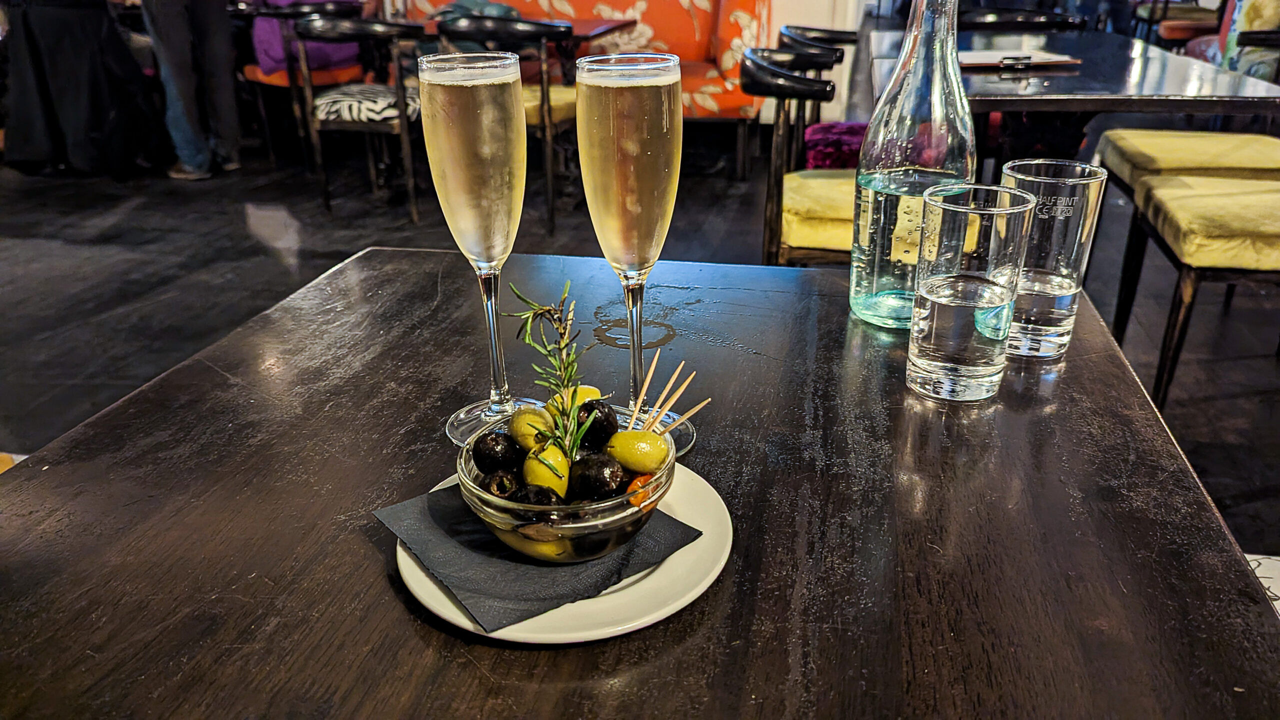 two glasses of Prosecco served with olives