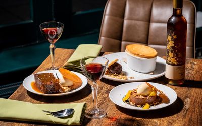 table laid out with desserts and wine