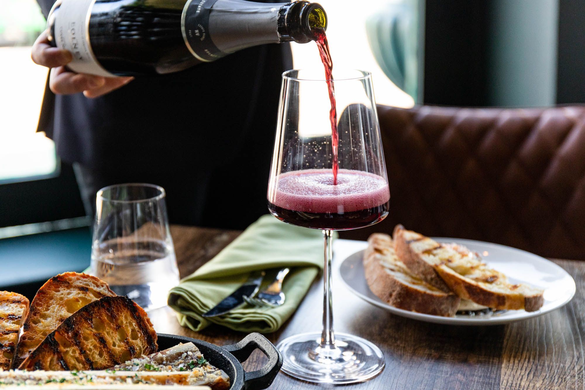 red wine being poured in the glass at Carne Hove