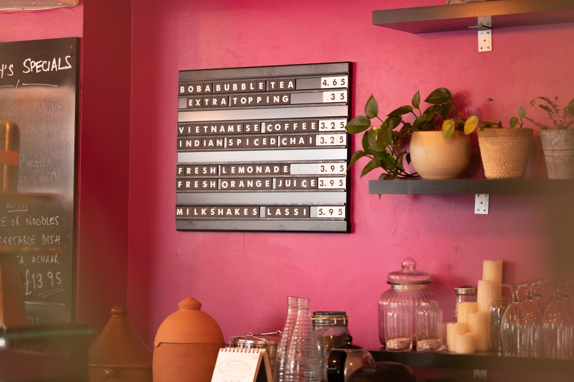 black board on the pink wall at the Nanima with restaurants drink offering
