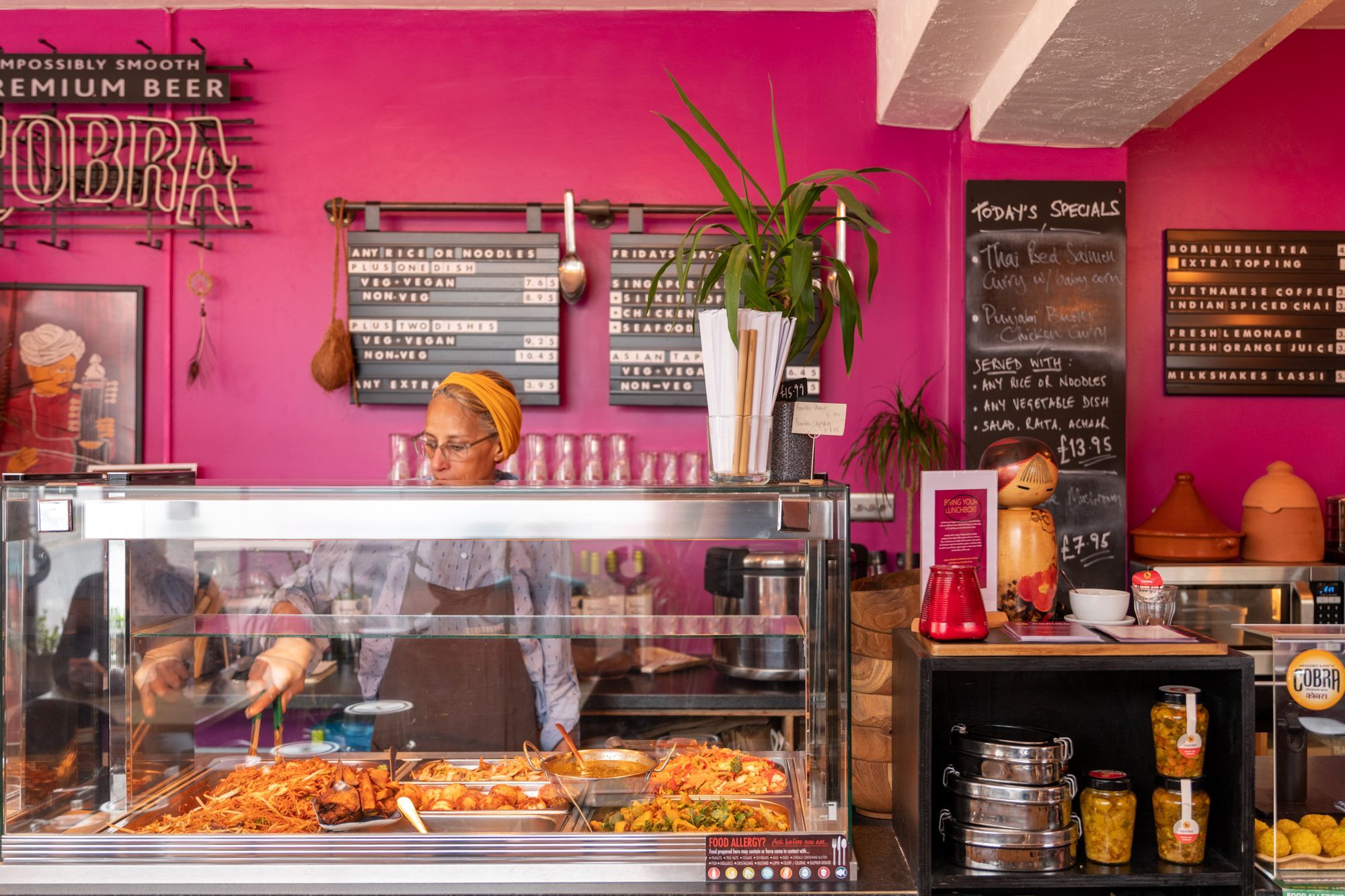 Nicky at Nanima taking food from metal boxes to serve to guests