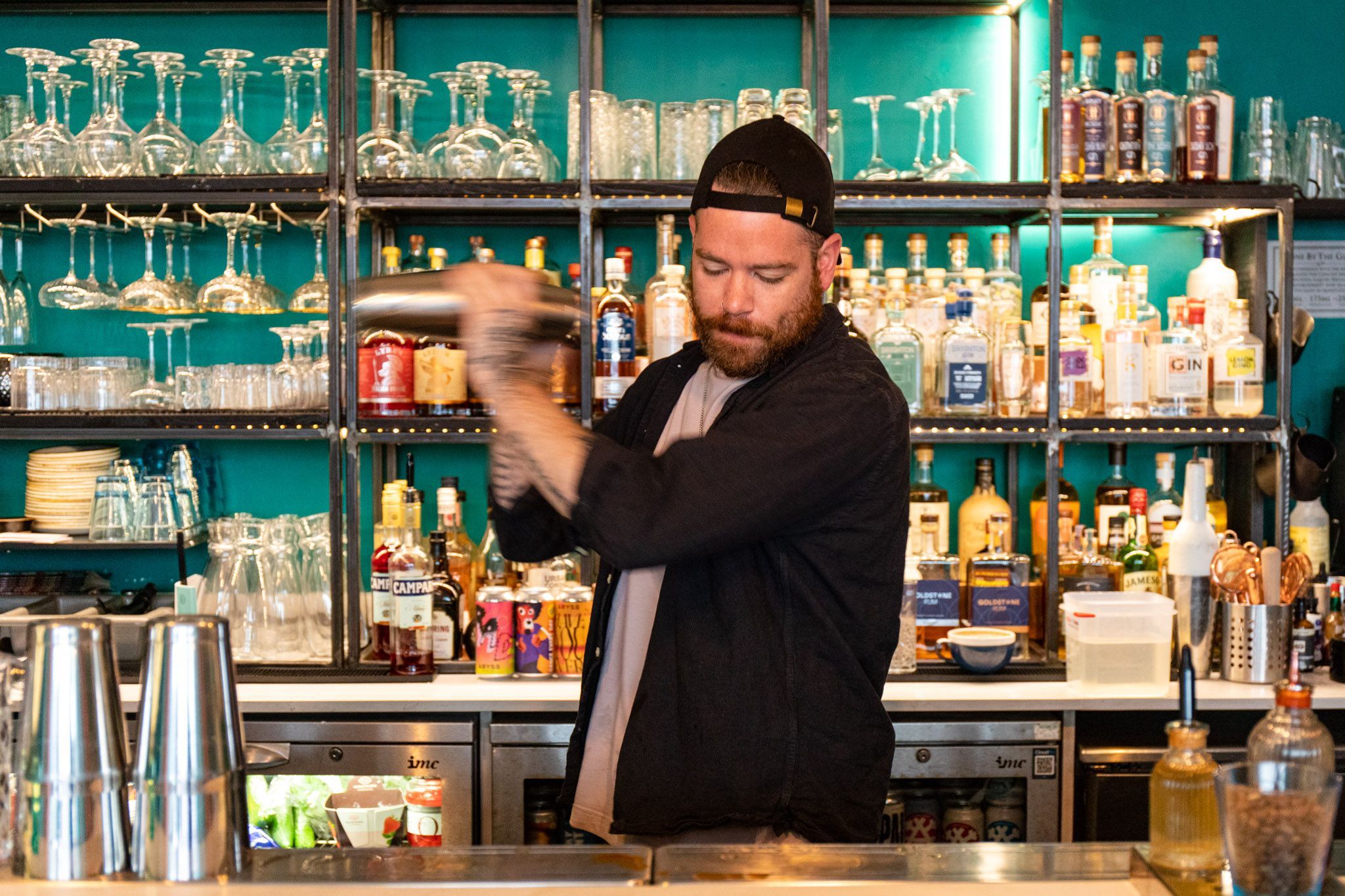 bartender shaking cocktail ingredients at Brighton Cocktail Co