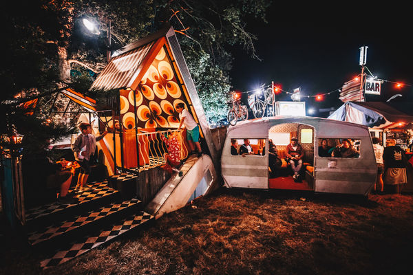 A venue at night with tents and a caravan for the Brighton Fringe food guide