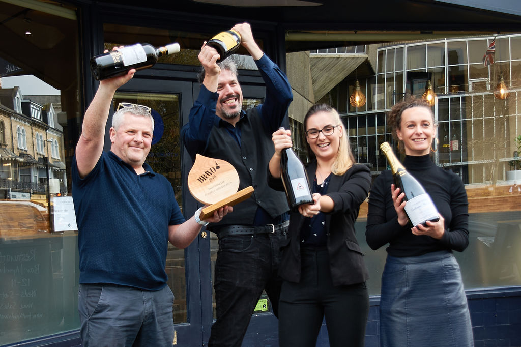 The team at Fourth and Church celebrating their award in front of the bar. Wine shop Brighton and Hove