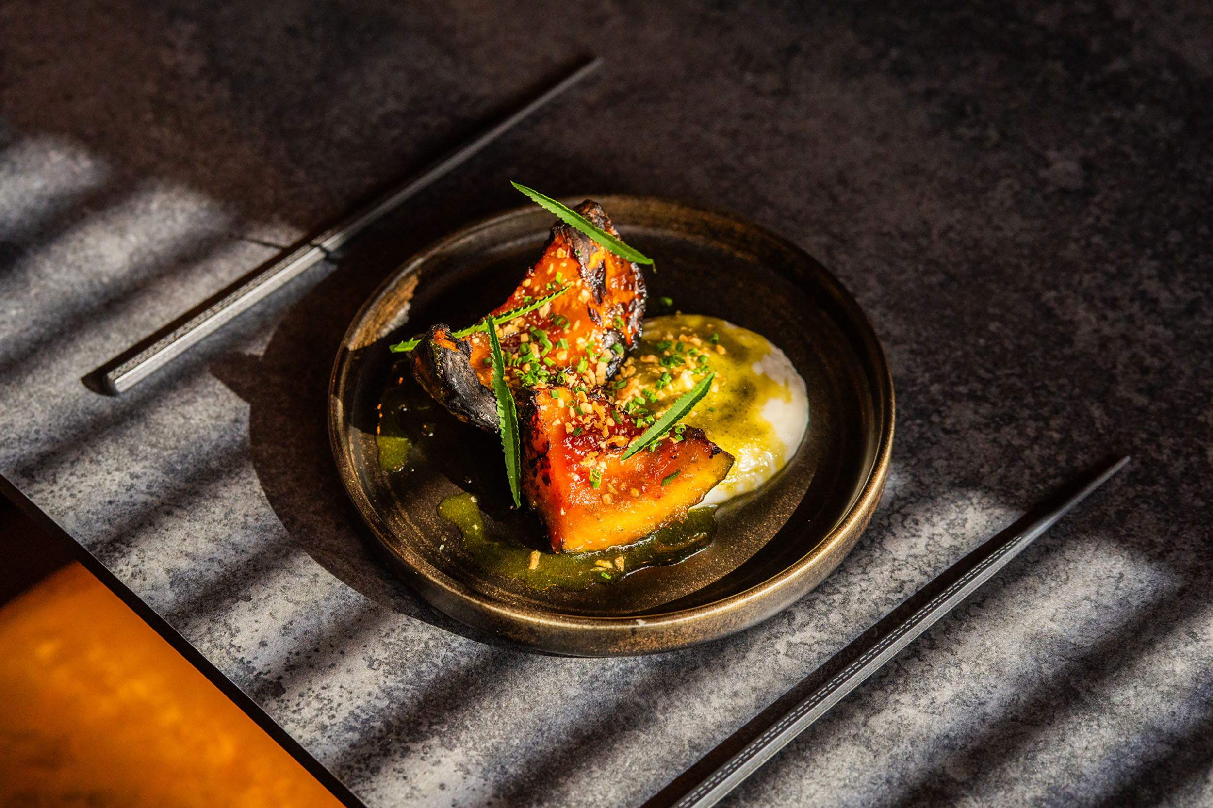 sweet potato dish served on black plate