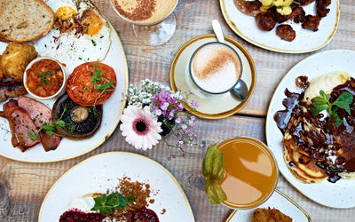 A selection of brunch dishes at Brighton cafe Moksha caffe with drinks.