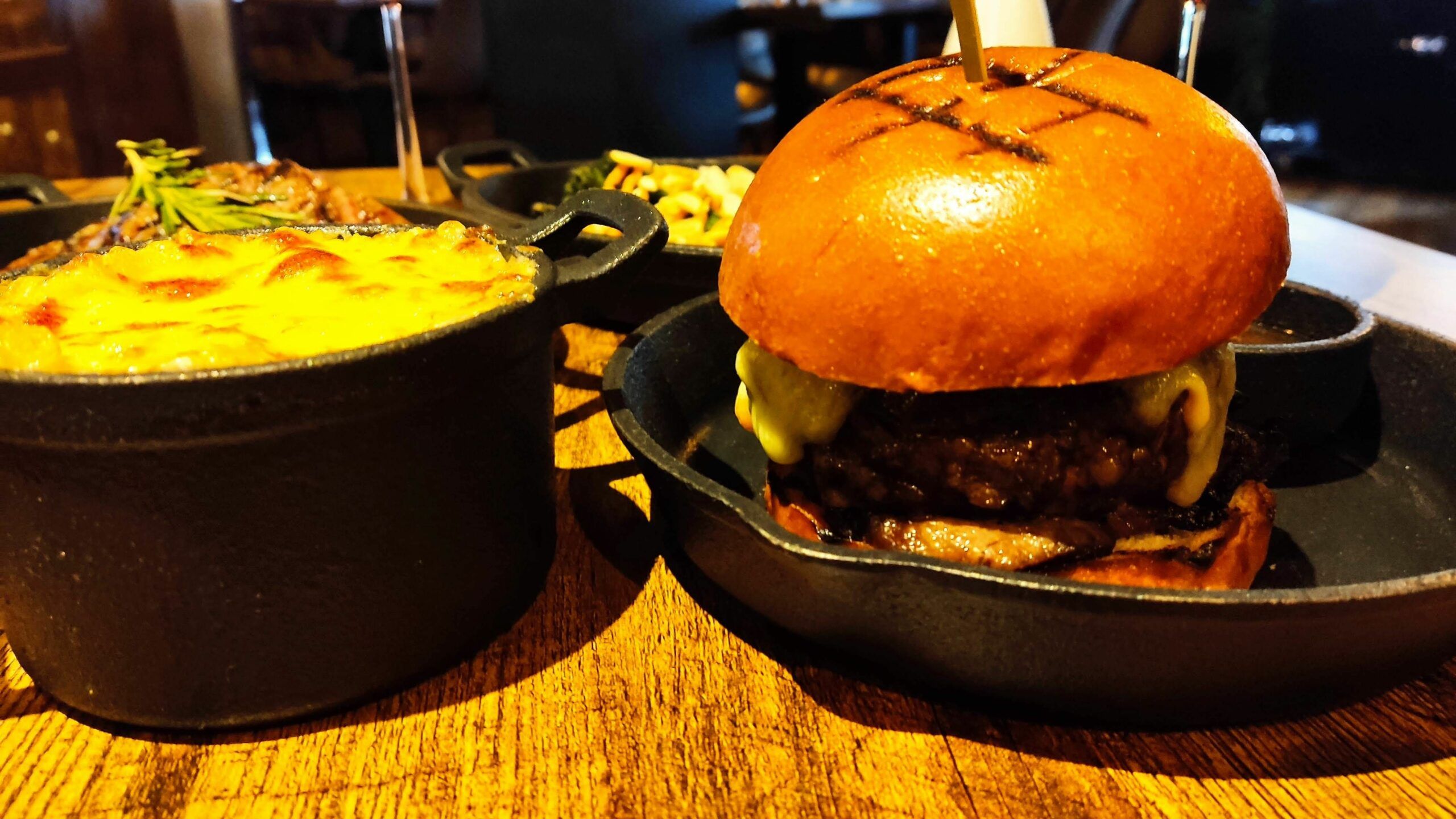 delicious meat burger on the black plate served with dripping gravy