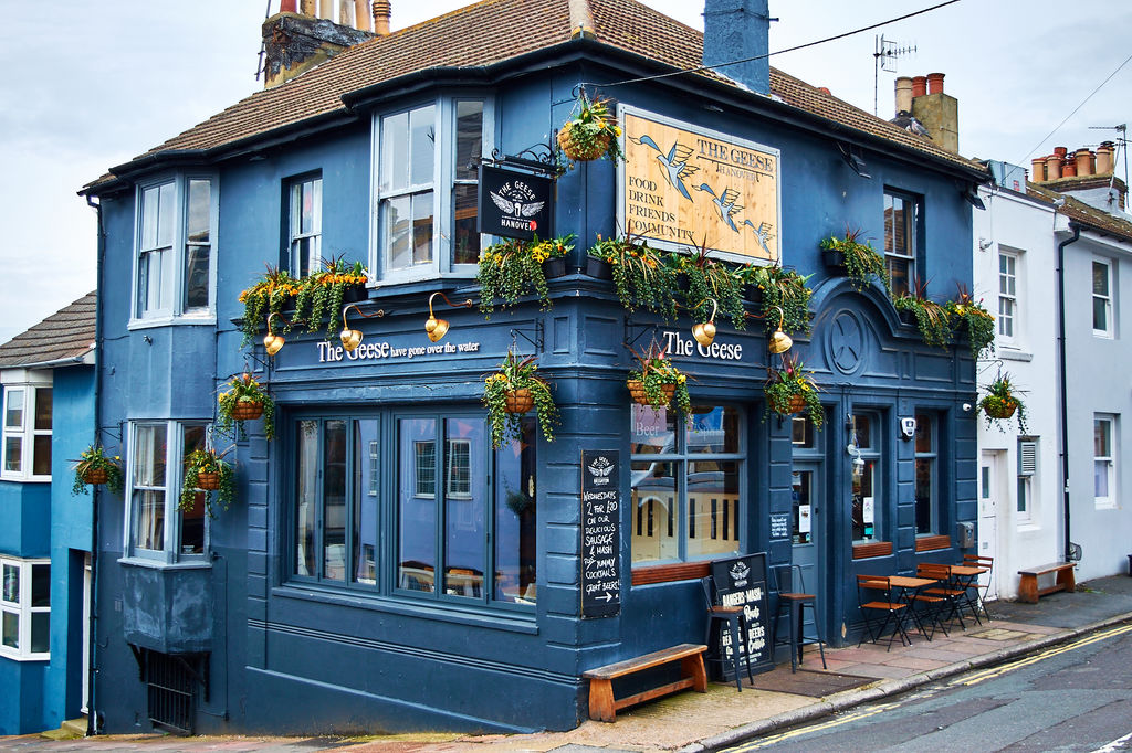 Exterior photo of The Geese pub in Hanover with hanging baskets full of flower and outside seating.